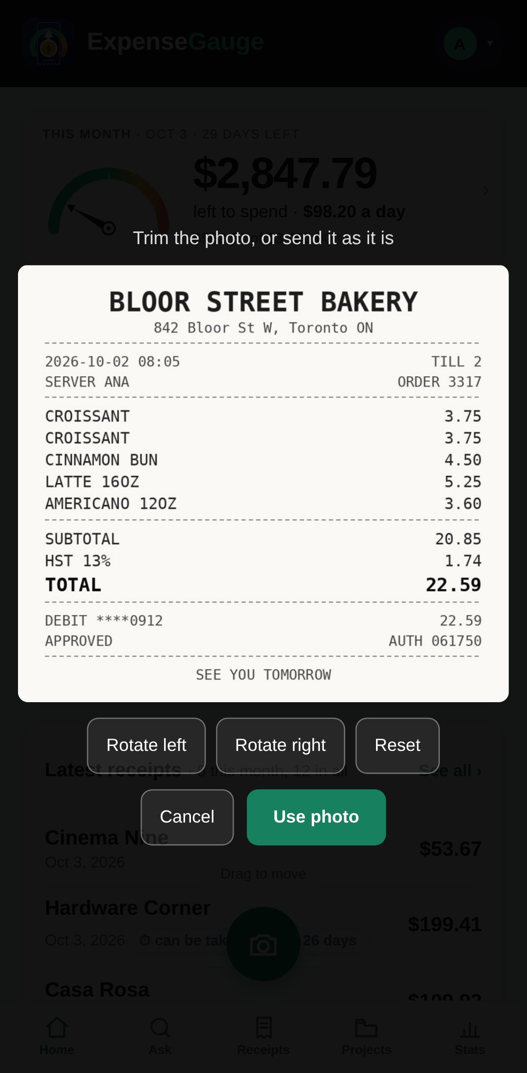 A phone in the receipt scanner of ExpenseGauge. A photographed bakery receipt sits in a frame with the words: trim the photo, or send it as it is. Below it are buttons to rotate left, rotate right, reset, cancel and use photo.